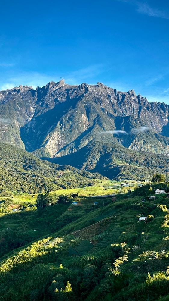 Mount Kinabalu above green Sabah hills